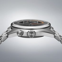 Close-up of a silver watch with detailed design on a gray background