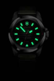 Black watch with green glowing face on a black background
