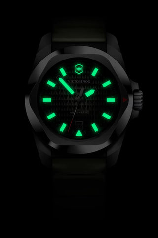 Black watch with green glowing face on a black background
