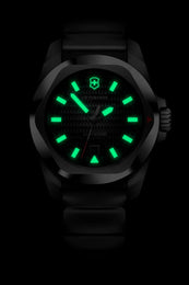 Black watch with green glowing face on a black background