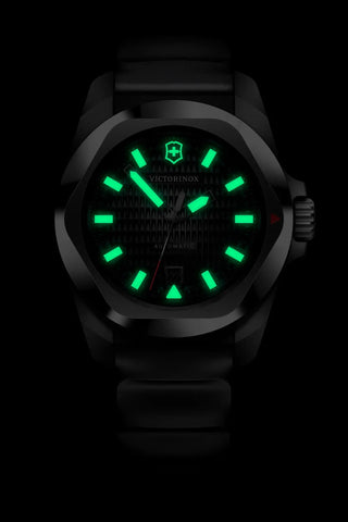 Black watch with green glowing face on a black background