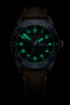 Black wristwatch with green digital display on a black background