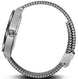 Close-up of a silver watch with a chain-like metal band on a white background