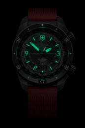 Watch with a dark face and red strap on a black background