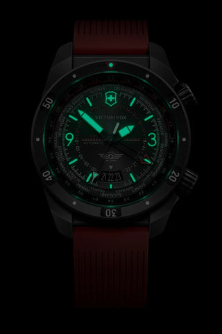 Watch with a dark face and red strap on a black background